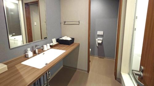 a bathroom with a sink and a mirror at Ｓｗｉｍｍｙ Ｉｎｎ Ｏｎａｇａｗａ - Vacation STAY 31622v in Onagawa