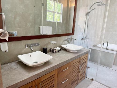 a bathroom with two sinks and a shower at Sanctuary Ceylon by Ceylon Spaces in Mount Lavinia