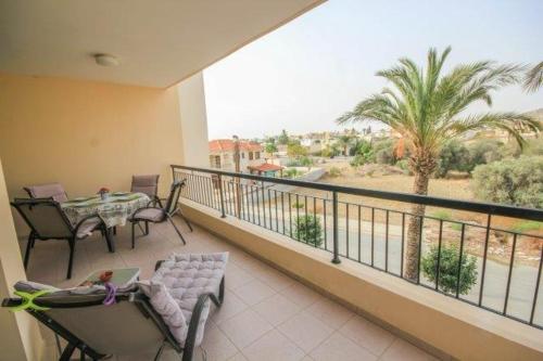 a balcony with a table and chairs and a view of the desert at Mediterranean Sunrise Apartments A2 in Voroklini