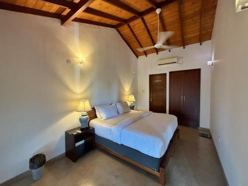 a bedroom with a bed with two lamps on it at Sanctuary Ceylon by Ceylon Spaces in Mount Lavinia