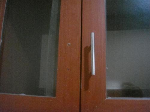 a wooden door with a window in a room at Hidden Pearl Hotel (Janus Luxury Suites) in Angeles