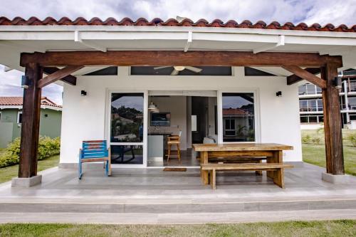 a patio with a wooden table and a bench at Cozy & Comfy 2BR Villa 7 at Playa Venao in Playa Venao
