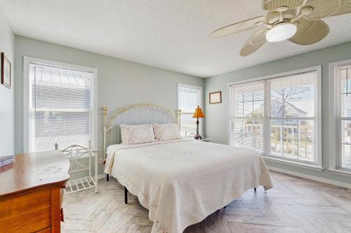 a bedroom with a bed and a ceiling fan at Bama Breeze in Dauphin Island