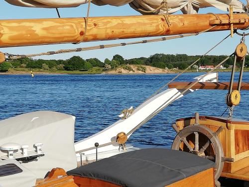 a boat on a body of water at Villa Ferie og Overnatning in Svendborg