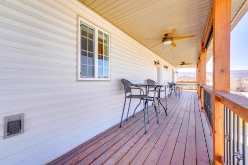 a wooden deck with chairs and a table on it at 2 Mi to Dinosaur Journey Museum Mtn-View Haven! in Fruita