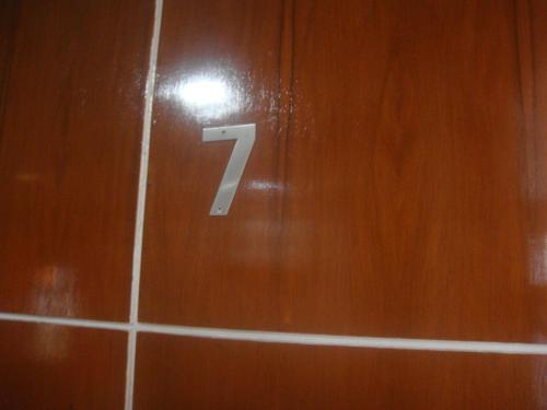 a number on a tiled wall in a bathroom at Hidden Pearl Hotel (Janus Luxury Suites) in Angeles
