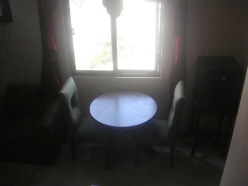 a dark room with a table and a window at Hidden Pearl Hotel (Janus Luxury Suites) in Angeles