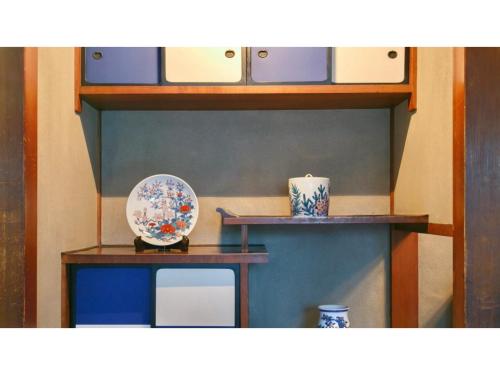 a shelf with two tables and a plate on it at Ryokan Akebono - Vacation STAY 20554v in Saga