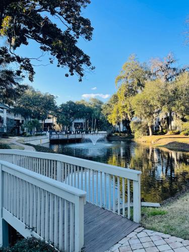 a bridge over a river next to a river with trees at 13 Beach Stop Hilton Head in Hilton Head Island