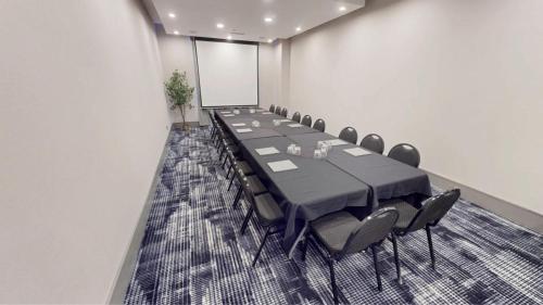 a conference room with a long table and chairs at Sandman Signature Calgary Airport Hotel in Calgary
