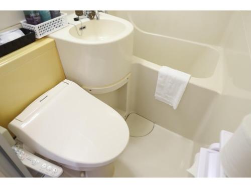 a bathroom with a white toilet and a sink at Business Hotel B,loom - Vacation STAY 38188v in Tanabe