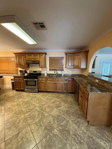 a large kitchen with wooden cabinets and granite counter tops at New Orleans Ponderosa in New Orleans