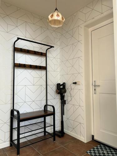 a room with a black shelf and a white wall at Appartement Sluyterman in Jorwerd