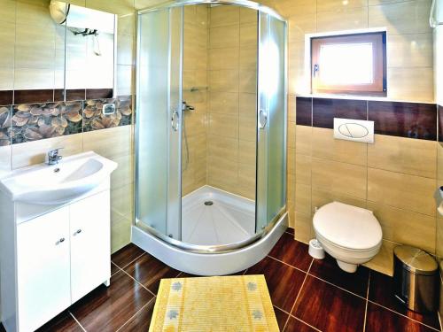 a bathroom with a shower and a toilet and a sink at Cottage in Sarbinowo near Baltic Sea Beach in Sarbinowo