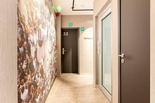 a hallway with a painting of people on the wall at Casa Española in Ath