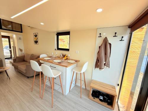 a kitchen and living room with a table and chairs at 446 Tiny House Zues in Shkodër