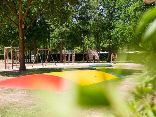 a park with a playground with play equipment in it at Eco Villa in Latour with Garden Sauna in Oirschot