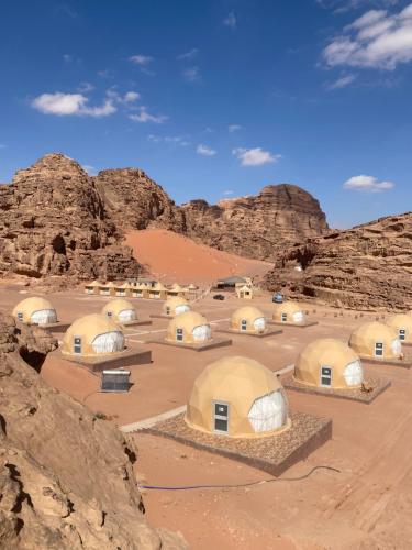 a group of domes in a desert with rocks at Wadi Rum Santa Camp in Wadi Rum