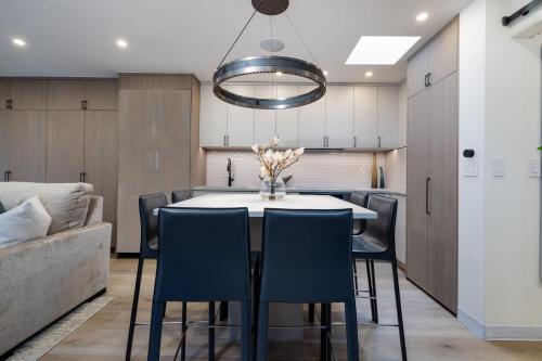 a kitchen and dining room with a table and chairs at 2 BR 3BA Condo - AC, Heated Pool, Walk to Town in Aspen