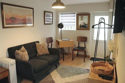 a living room with a couch and a table at The Waveney in Keynsham