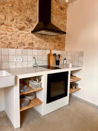 a kitchen with a sink and a stove top oven at Casa Anguila in Amposta