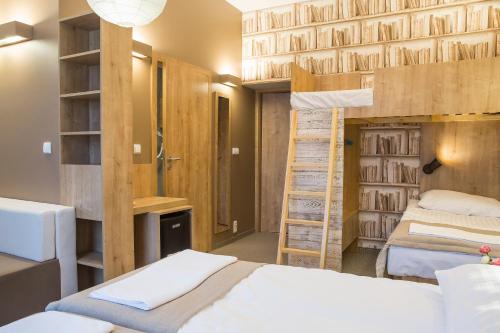 a bedroom with two bunk beds and a ladder at Willa Sudety in Kudowa-Zdrój