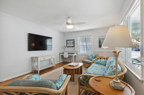a living room with a table and chairs and a tv at Rec Players Retreat in Carolina Beach