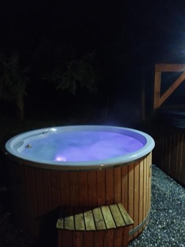 a hot tub in a backyard at night at Wellness Chata na Vysočině in Bohdalov