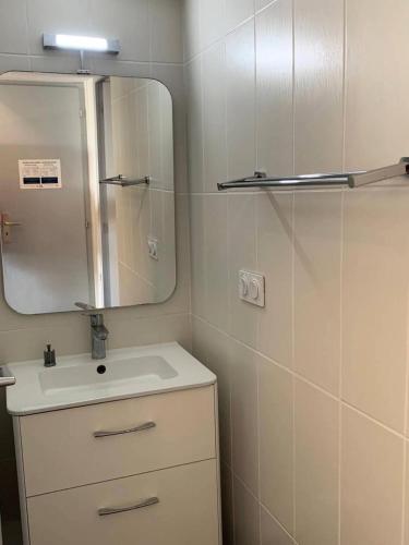 une salle de bain avec un lavabo et un miroir dans l'établissement Résidence Port Nature Colline 4 - Appartement T2 4 pers. - Port Nature Colline 4 MAE-2774, au Cap d'Agde