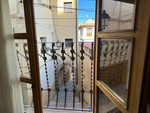 a view of a balcony from a window at VUT Casa Orrios, en el centro de Alcañiz. in Alcañiz
