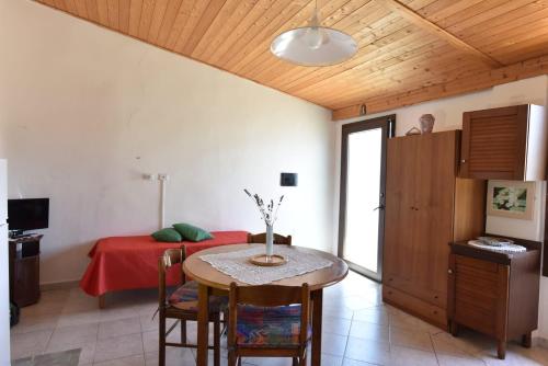 a room with a table and a bed in it at Su Cuile historical country house with barbecue in Martis
