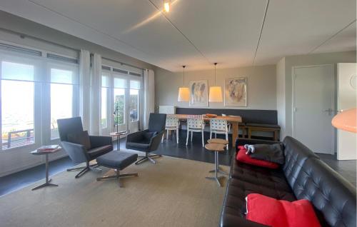 a living room with a couch and a table at 3 Bedroom Amazing Home In Wieringerwerf in Wieringerwerf