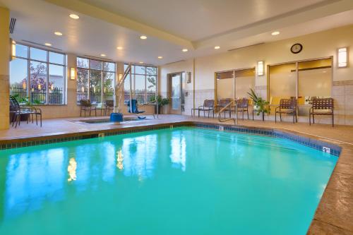 a large swimming pool with blue water in a building at Hilton Garden Inn Salt Lake City/Sandy in Sandy