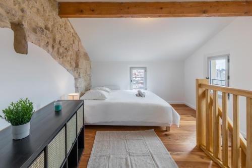 a bedroom with a large bed and a staircase at Le Panorama - Rooftop & Climatisation in Montpellier