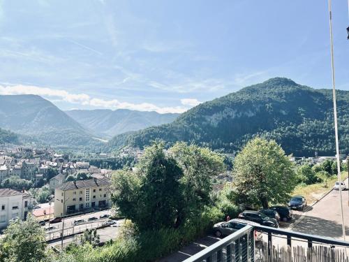 a view of a city with mountains in the background at Le balcon du boulevard bellevue in Saint-Claude