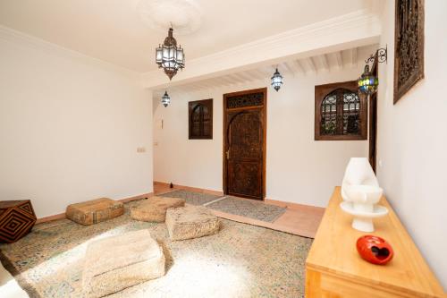 a living room with a large door and a table at Dasofinya lodges in Touggana