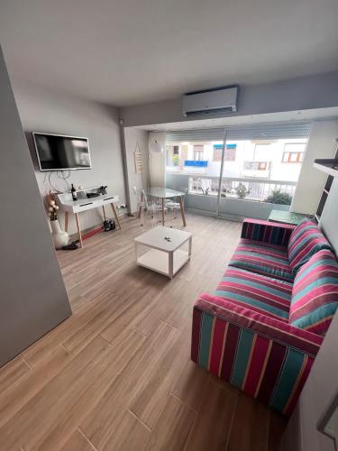 a living room with a couch and a table at Studio at the heart of Carre D'or 2 mins Sea Wi-fi in Nice