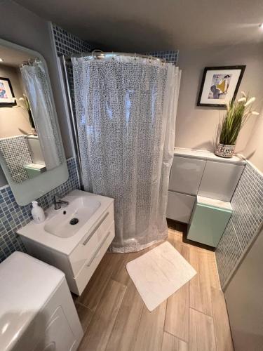 a bathroom with a shower curtain and a sink at Studio at the heart of Carre D'or 2 mins Sea Wi-fi in Nice