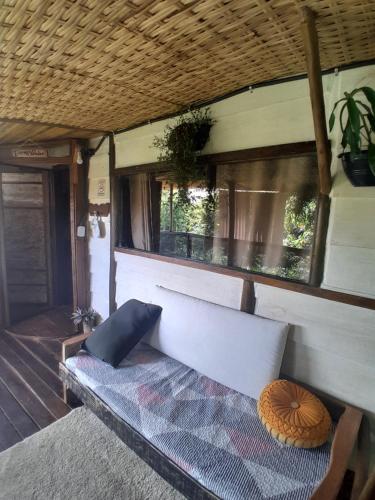 a couch sitting on the porch of a house at Chalé Bambu3 in Cunha