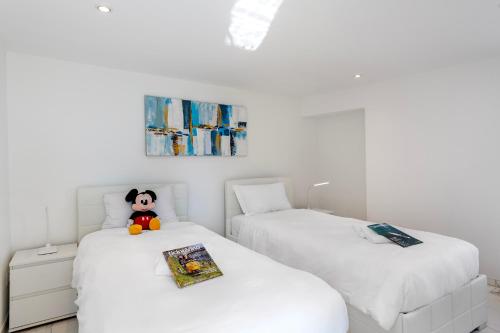 ロンコ・ソプラ・アスコナにあるRed View Apartment - Happy Rentalsの白い壁の部屋にベッドが2つある