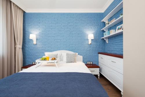 a blue bedroom with a bed and a blue brick wall at Casa Dolce far niente , in Blue, PARKING in Sofia