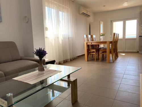 a living room with a couch and a table at Apartments Maris in Maslenica