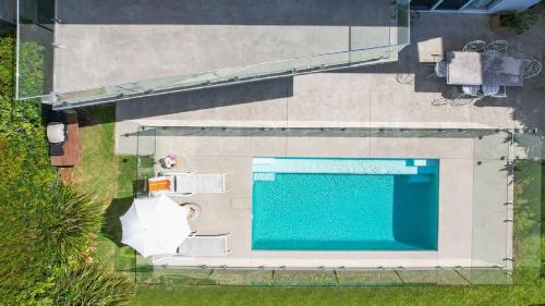 an overhead view of a large swimming pool at Stunning Ocean Views and Pool in Hardys Bay