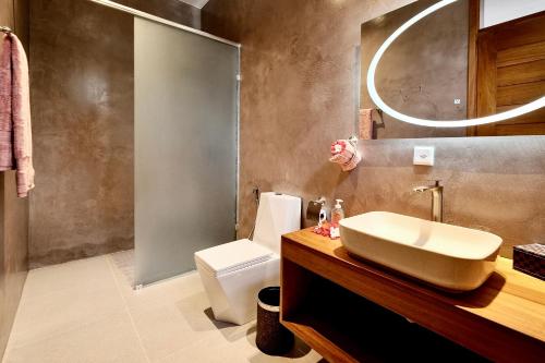 a bathroom with a sink and a toilet at Zanzibar - Villa Sumo apartment - Kiwengwa in Kiwengwa