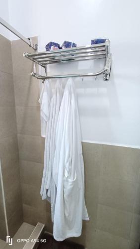 a towel rack in a bathroom with white towels at Scenic Serenity at Pearl Marina in Entebbe
