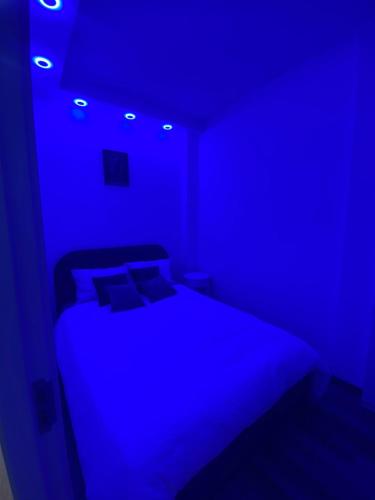 a blue bedroom with a bed in a room at Relax In in Belgrade