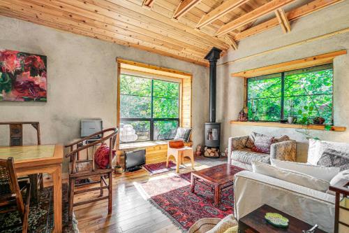 a living room with a couch and a table at Unique and Serene Retreat, 7 Mi to Downtown Portland in Portland