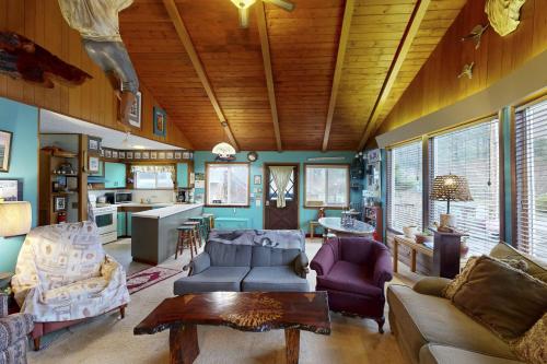 a living room with a couch and a table at Darrs Beach Cottage in Neskowin