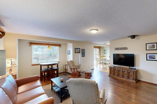 a living room with a couch and a flat screen tv at 2 Bed 1 Bath Vacation home in Seaside in Seaside
