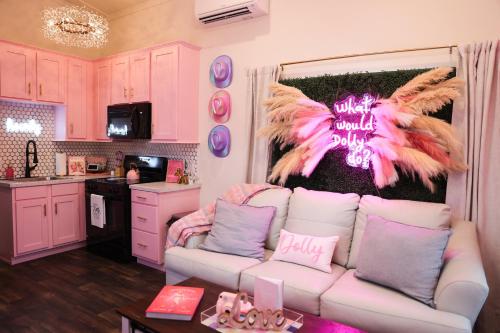 a living room with a white couch with feathers on the wall at Dolly's Place 6260 in Dover